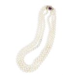 A CULTURED PEARL AND AMETHYST NECKLACE, composed of three rows of graduated cultured pearls
