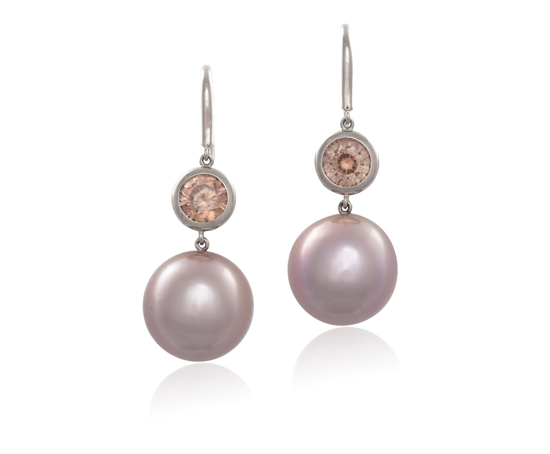 A PAIR OF CULTURED PEARL AND ZIRCON PENDENT EARRINGS, each composed of a circular pinkish-orangy