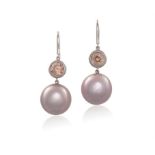 A PAIR OF CULTURED PEARL AND ZIRCON PENDENT EARRINGS, each composed of a circular pinkish-orangy
