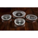 A COLLECTION OF FOUR CUT GLASS DISHES, each of different sizes and variations of diamond cut and