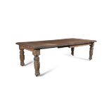 A CARVED OAK EXTENDING DINING TABLE, 19th Century, the rectangular top with leaf carved edge and