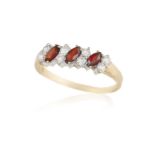 A GARNET AND DIAMOND RING, composed of three marquise-shaped garnets between brilliant-cut diamonds,