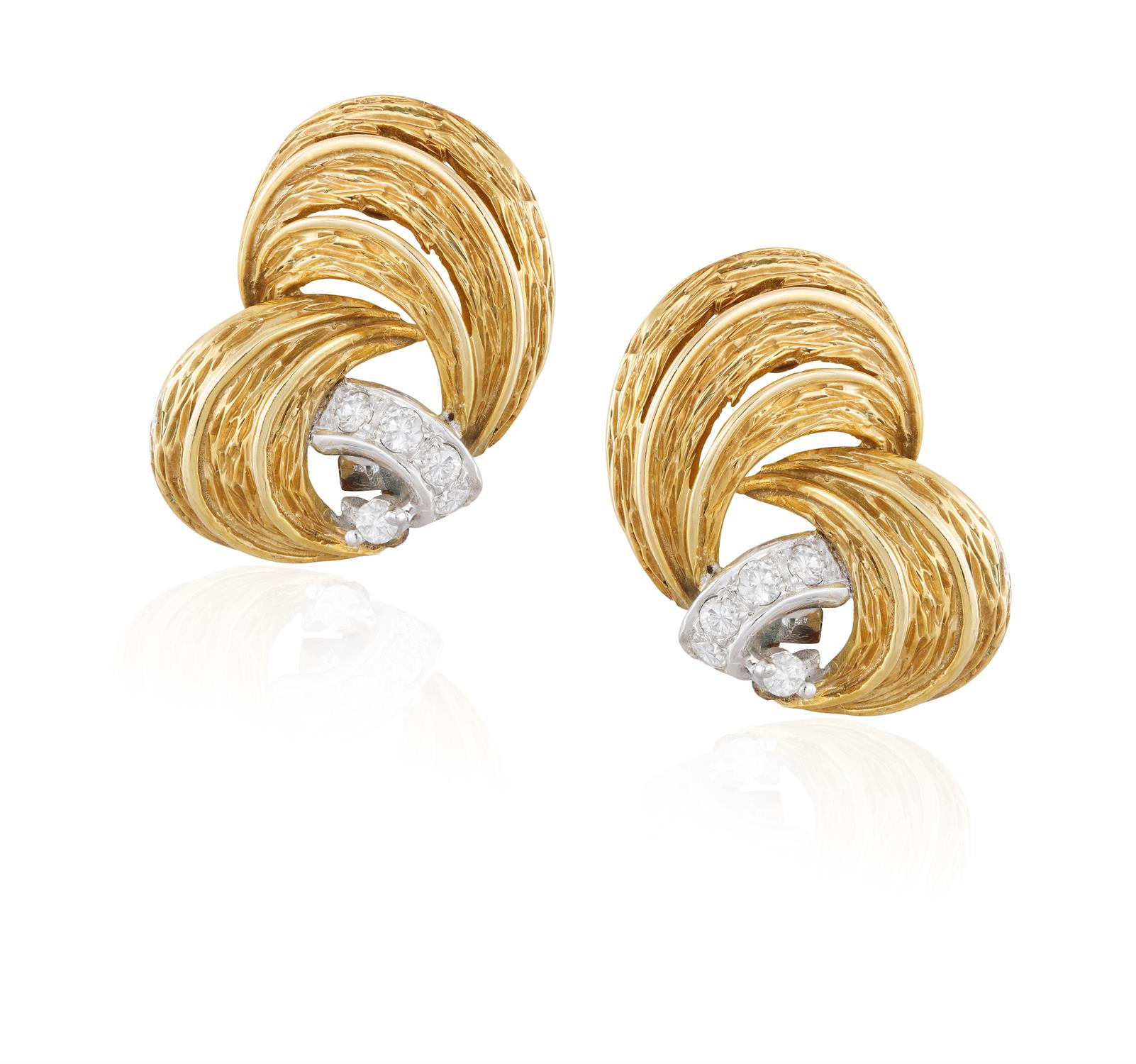 A PAIR OF DIAMOND EARCLIPS, each textured gold earclip highlighted with brilliant-cut diamond