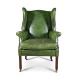 A GEORGE III MAHOGANY AND LEATHER UPHOLSTRED WING-BACK ARMCHAIR, covered in green hide with