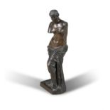 A FRENCH BRONZE FIGURE OF VENUS, after the antique with draped toga and standing on plinth base,