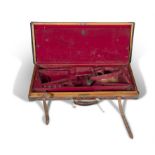 A 19TH CENTURY LEATHER GUN CASE, by Holland & Holland of London, set with brass corner mounts and