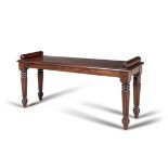 A GEORGE IV STYLE MAHOGANY WINDOW SEAT, of rectangular form, with moulded edge, twin cylinder