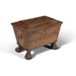 AN IRISH WILLIAM IV MAHOGANY WINE COOLER, of sarcophagus shape with leaf cast brass ring handles,