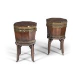 A PAIR OF MAHOGANY AND BRASS BOUND WINE COOLERS, 19th century, of octagonal form,