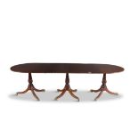 A 19TH CENTURY MAHOGANY EXTENDING D-END DINING TABLE, with plain oval top supported on three fluted