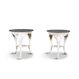 A MATCHED PAIR OF PAINTED CAST IRON CIRCULAR GARDEN TABLES, the rouge marble tops raised on three