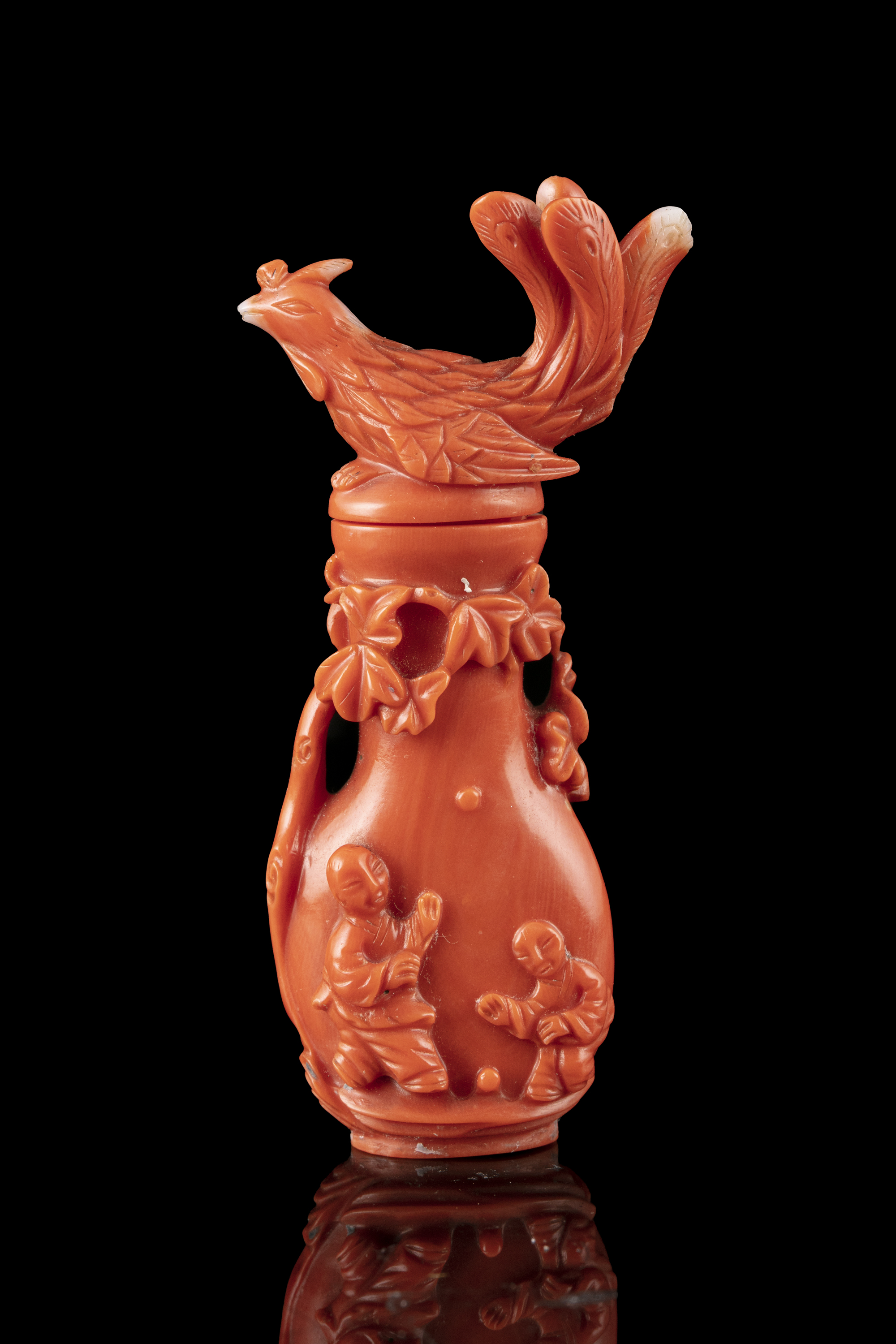 *A CARVED RED CORAL 'PHOENIX AND BOY' SNUFF BOTTLE WITH MATCHING STOPPER China, Early 20th century