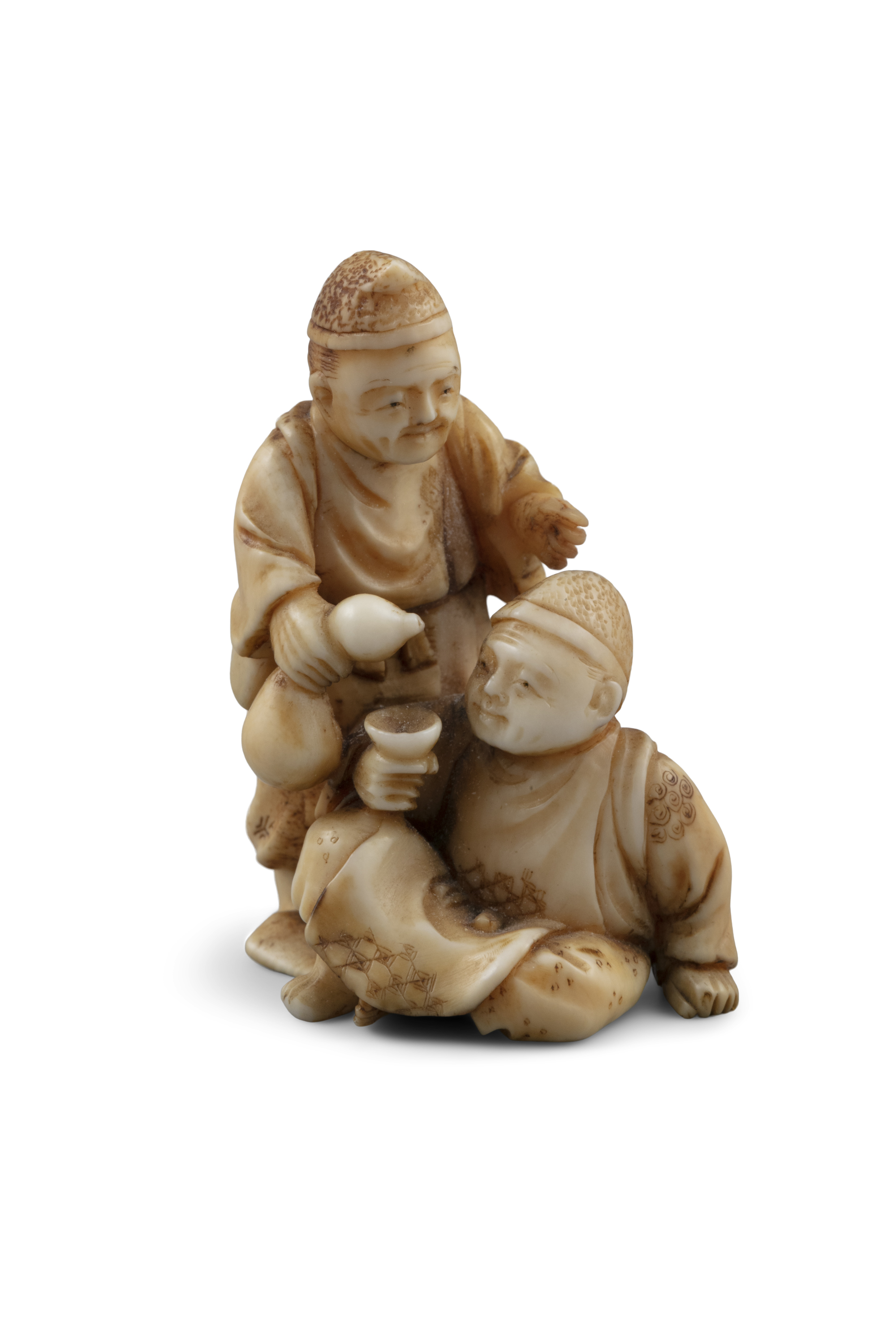 *ICHIGYOKU一玉: AN IVORY 'TWO MEN DRINKING WINE' KATABORI NETSUKE Japan, Meiji period Pierced with two