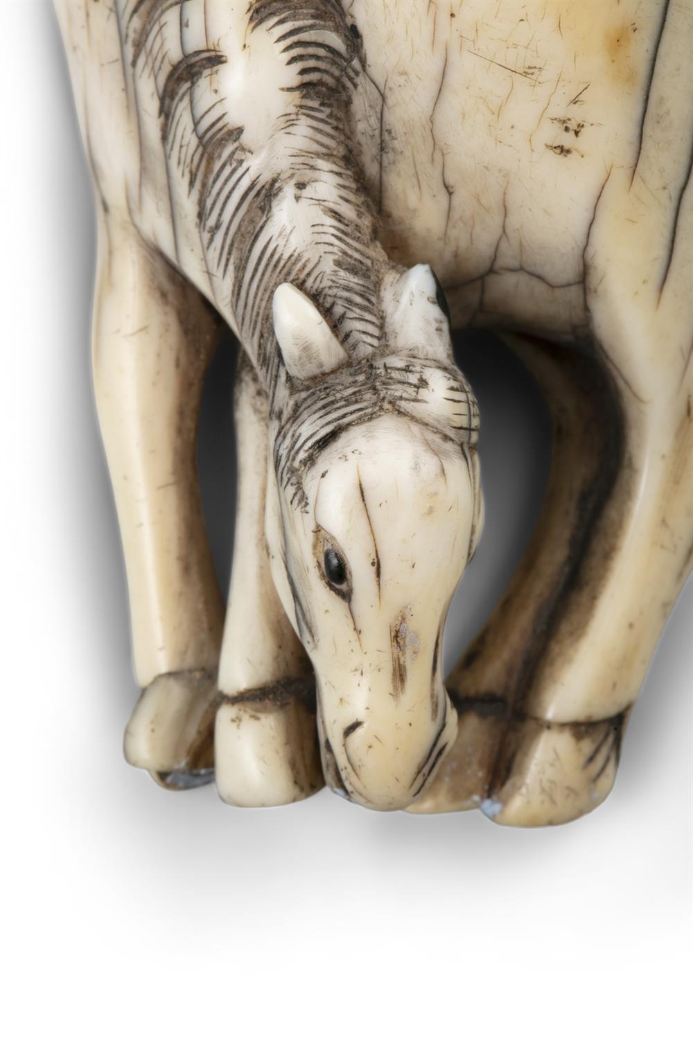 *AN IVORY 'GRAZING HORSE' KATABORI NETSUKE Japan, Edo period Unsigned. Pierced with two himotoshi. - Image 5 of 6