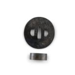 A NAGA MARU GATA TSUBA WITH SIGNATURE Japan, Edo period Wrought copper with shakudo finish,