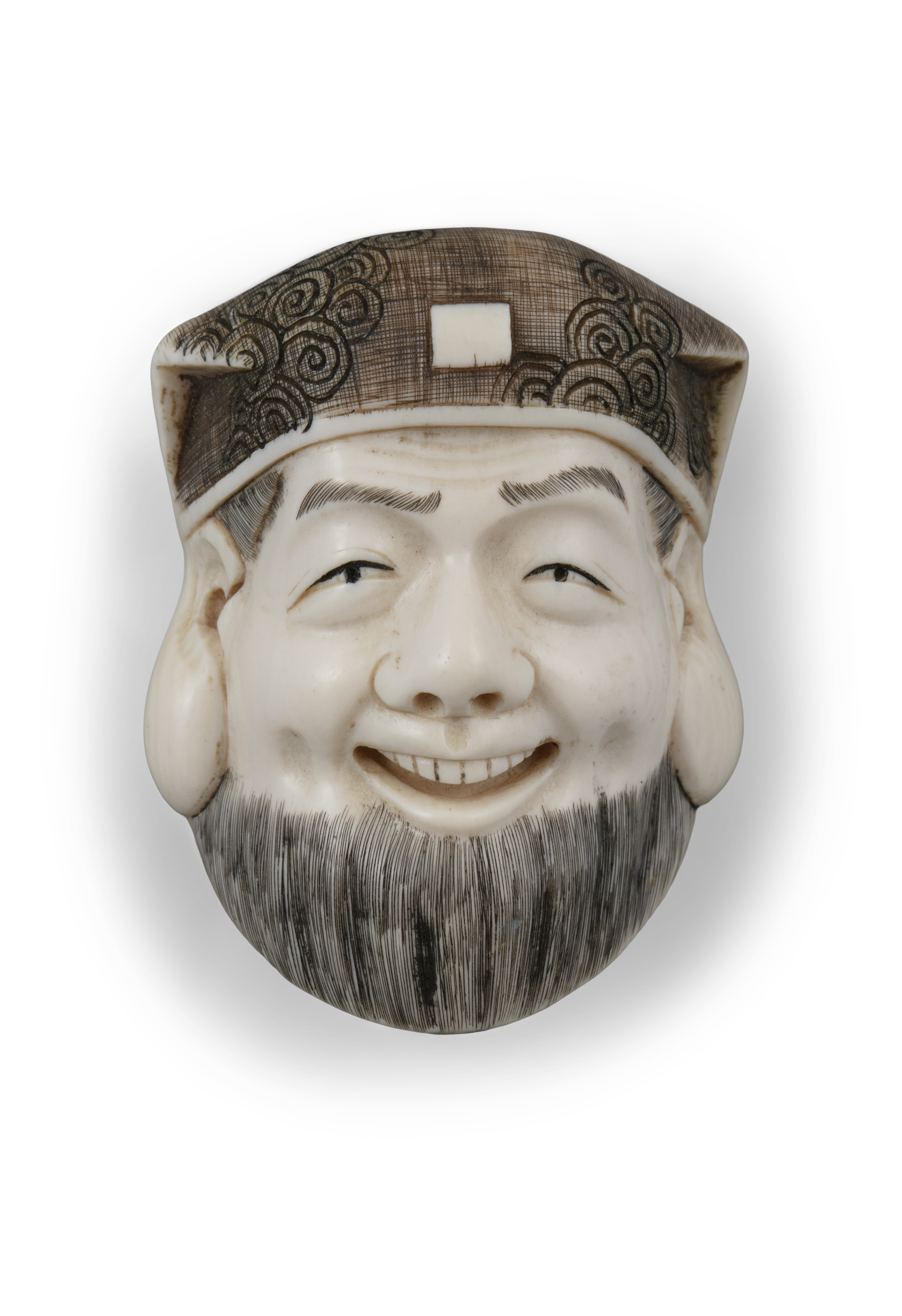 *A SIGNED IVORY 'FACE' KATABORI NETSUKE Japan, Meiji to Taisho period With a signature,