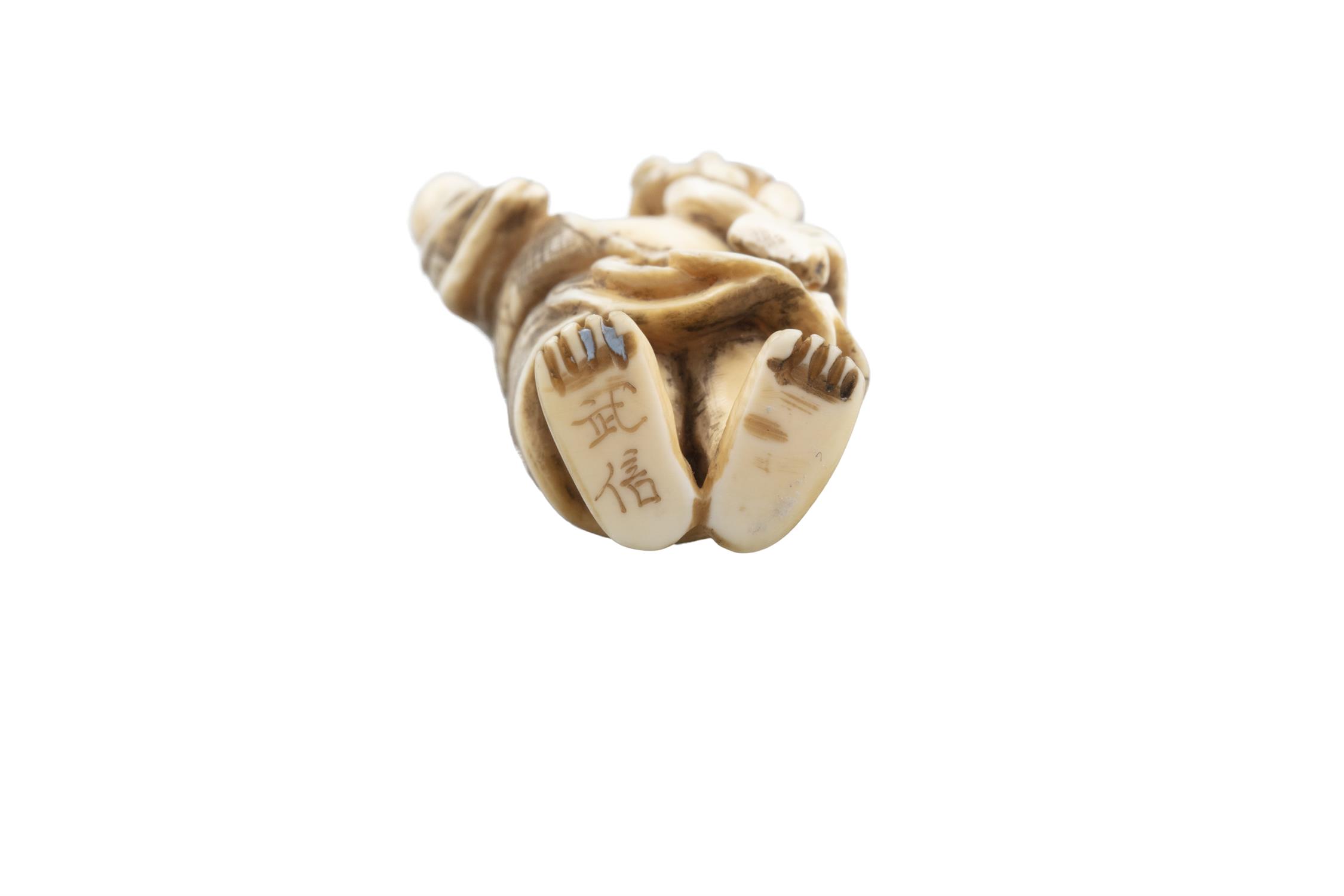 *TAKENOBU 武信 - AN IVORY 'ONI' KATABORI NETSUKE Japan, 19th century Pierced with two himotoshi. - Image 9 of 10