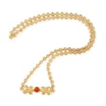 A CORAL AND GOLD NECKLACE, BY CARTIER The circular-link row necklace, set with two polished