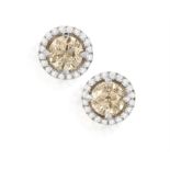 A PAIR OF COLOURED DIAMOND AND DIAMOND EARSTUDS Each brilliant-cut diamond weighing