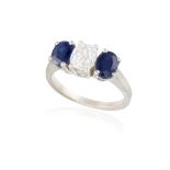 A SAPPHIRE AND DIAMOND THREE-STONE RING The central old cushion-shaped diamond within a