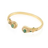 AN EMERALD AND DIAMOND BANGLE The reeded gold bangle with two terminals set with oval-shaped