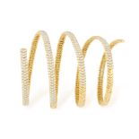 A DIAMOND BRACELET The coiled gold spring bracelet pave-set with brilliant-cut diamonds to the