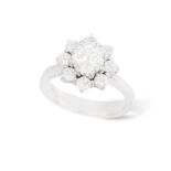 A DIAMOND CLUSTER RING The central brilliant-cut diamond within an eight-claw setting weighing