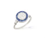 AN EARLY 20TH CENTURY SAPPHIRE AND DIAMOND TARGET RING The central old brilliant-cut diamond
