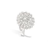 A DIAMOND FLOWER PENDANT/BROOCH Modelled as a stylised flower, the petals, pistils and leaves