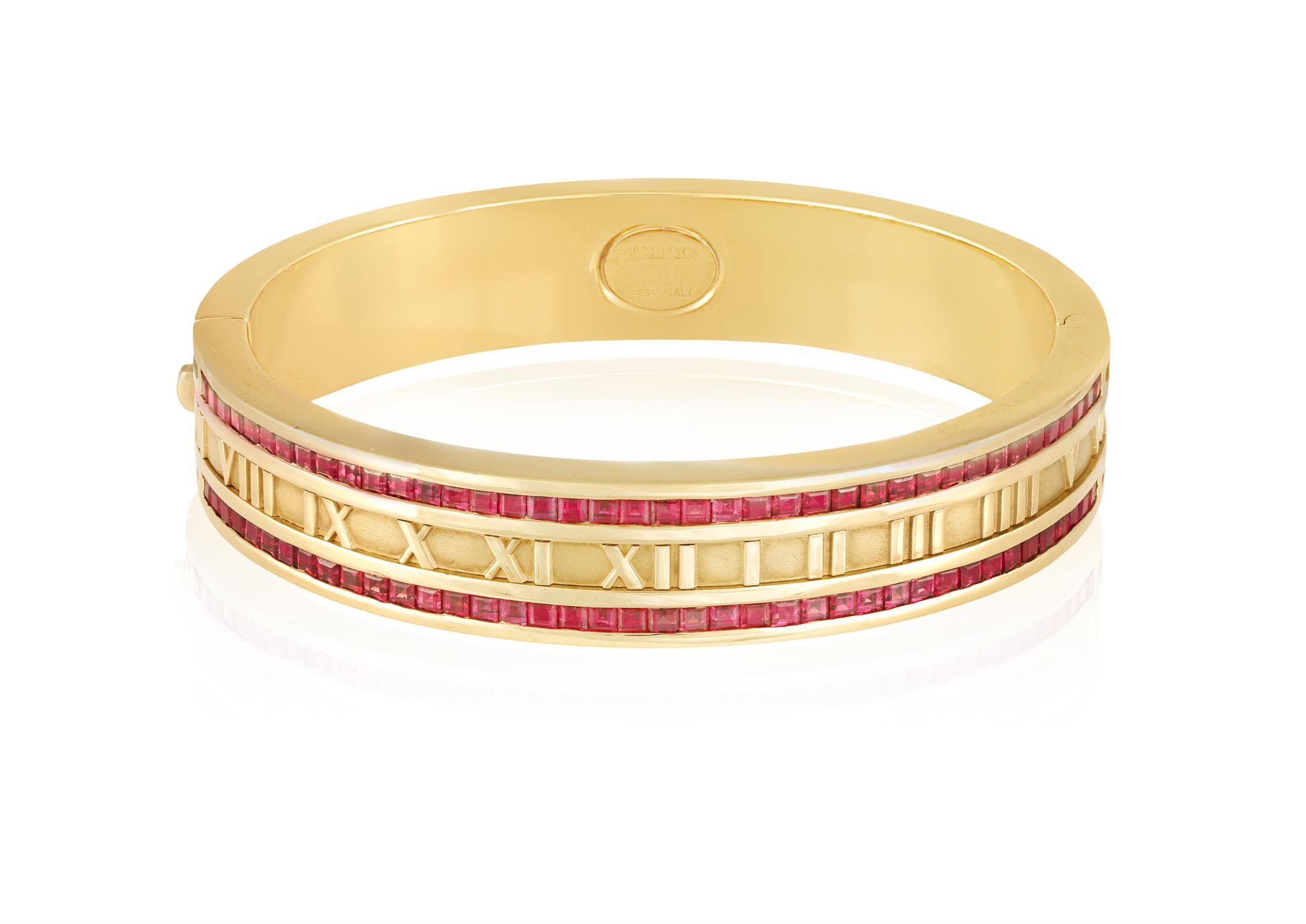 A RUBY-SET 'ATLAS' BANGLE, BY TIFFANY & CO., 1995 The hinged bangle with Roman numerals in