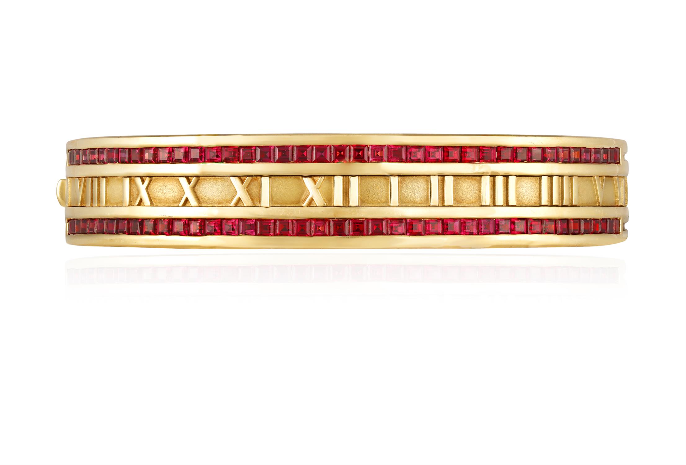 A RUBY-SET 'ATLAS' BANGLE, BY TIFFANY & CO., 1995 The hinged bangle with Roman numerals in - Image 2 of 2