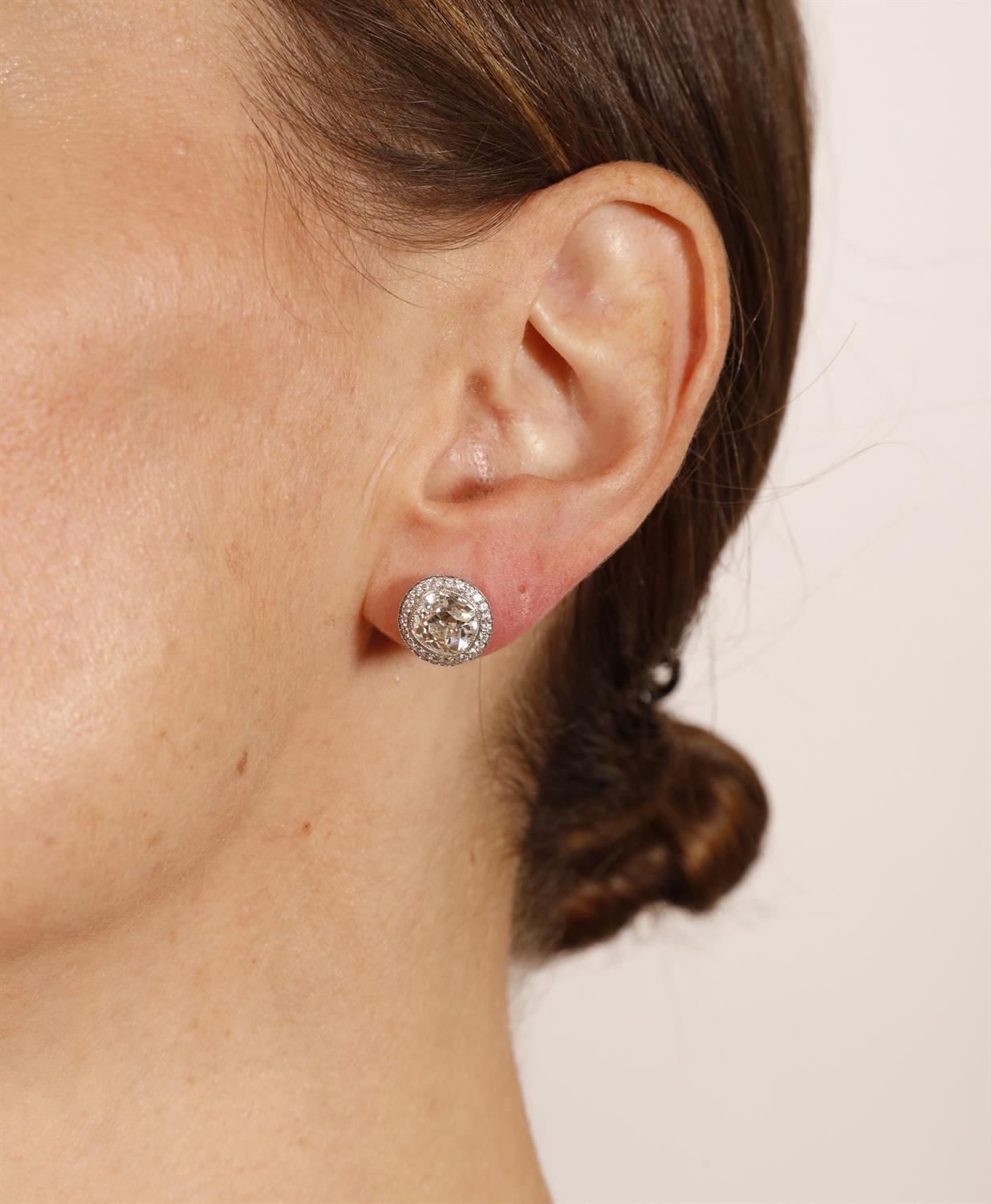 A PAIR OF DIAMOND EARSTUDS Each old cushion-shaped diamond within collet-setting and a halo of - Image 3 of 3