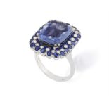 A SAPPHIRE AND DIAMOND DRESS RING The central cushion-shaped sapphire weighing approximately 6.