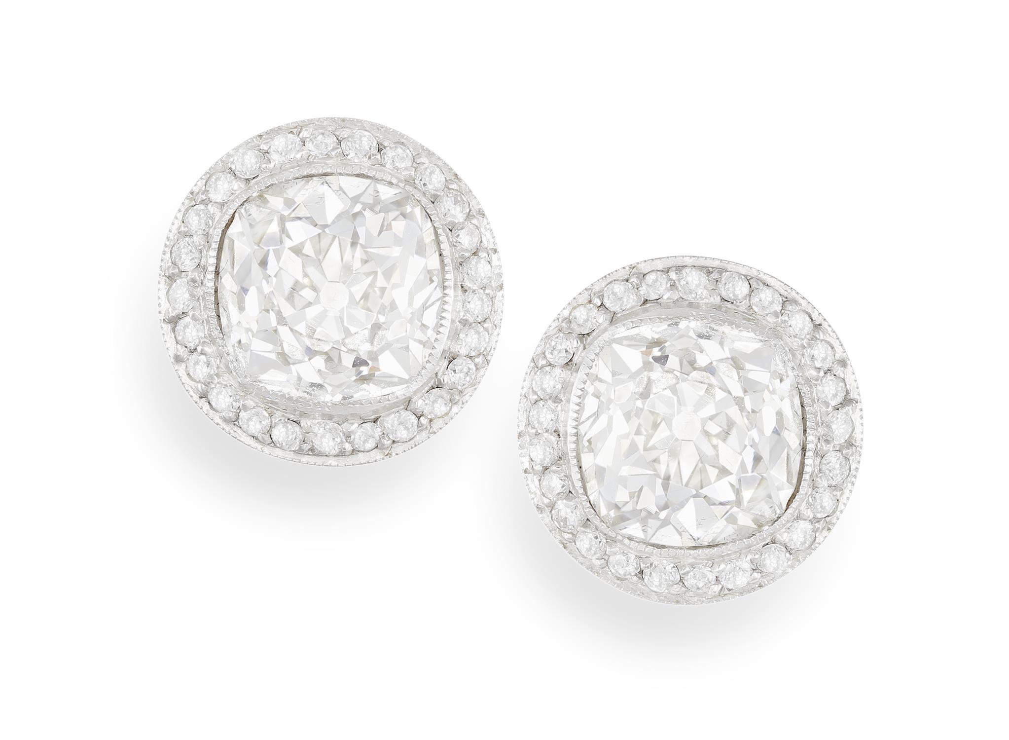 A PAIR OF DIAMOND EARSTUDS Each old cushion-shaped diamond within collet-setting and a halo of