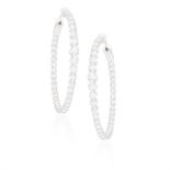 A PAIR OF DIAMOND HOOP EARRINGS Each hoop set with a graduating series of brilliant-cut diamonds,