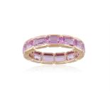 A COLOURED SAPPHIRE ETERNITY RING Composed of a continuous line of rectangular-cut pink