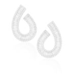 A PAIR OF DIAMOND EARRINGS Of swirl design, each composed of a central line of tapered