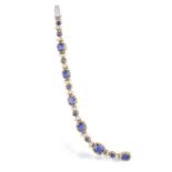A SAPPHIRE AND DIAMOND BRACELET Composed of six graduated cushion-shaped sapphires with