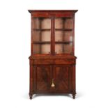 A WILLIAM IV FLAME MAHOGANY BOOKCASE, c.1830, of rectangular form with cavetto cornice above twin