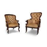 TWO VICTORIAN MAHOGANY FRAMED ARMCHAIRS, of similar style, each covered with brown button back hide,