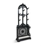 A VICTORIAN PAINTED CAST IRON HALL STAND, the domed open back plate with foliate scrolls and nine