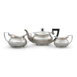 AN EDWARDIAN SILVER THREE PIECE BACHELOR'S TEA SERVICE, Birmingham c.1905, maker's marks rubbed,