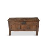 A 17TH CENTURY COMPACT CARVED OAK CHEST, the rectangular hinged lid above a carved three field