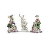 A COLLECTION OF POLYCHROME PORCELAIN FIGURES, comprising a pair of seated male and female figures