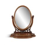 A VICTORIAN MAHOGANY DRESSING TABLE MIRROR, the oval mirror supported by scroll upright,