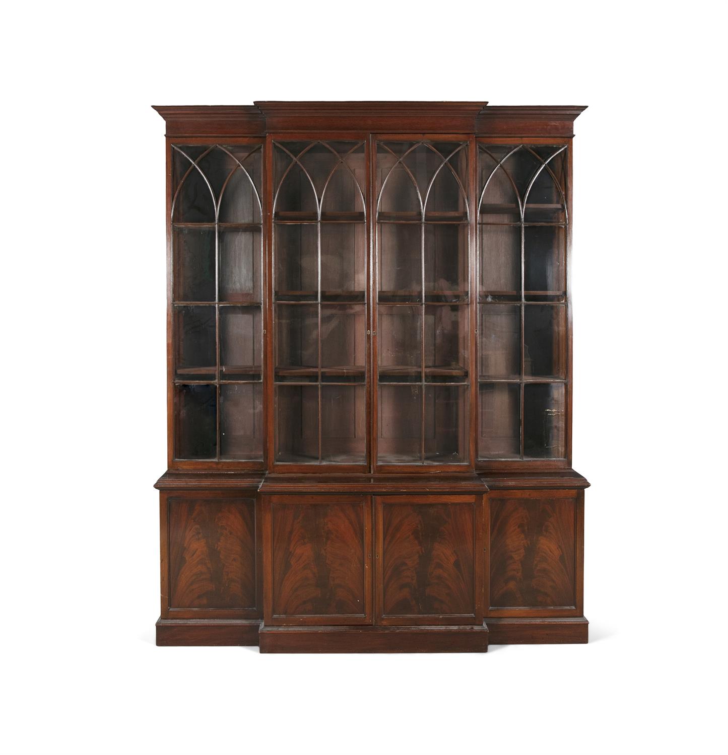 A GEORGE III STYLE FLAME MAHOGANY BREAKFRONT BOOKCASE, the top section with moulded cornice,