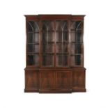 A GEORGE III STYLE FLAME MAHOGANY BREAKFRONT BOOKCASE, the top section with moulded cornice,