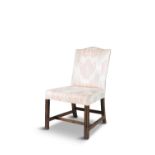 A GEORGE III MAHOGANY FRAMED SIDE CHAIR, the rectangular padded back with serpentine crest,