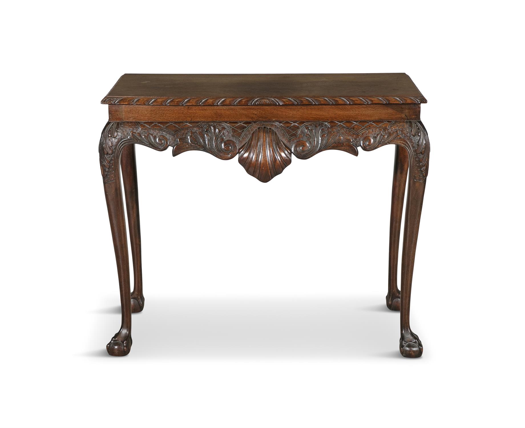 A GEORGIAN MAHOGANY SIDE TABLE, of rectangular form, the top with gadrooned rim, above carved apron