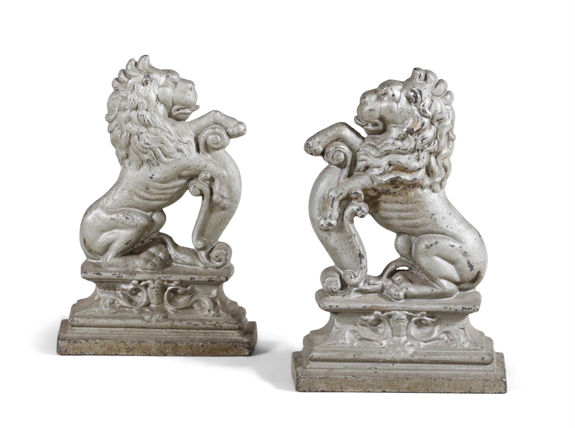 A PAIR OF 19TH CENTURY CAST IRON DOOR STOPS, painted in 'off white' and modelled as lions rampant